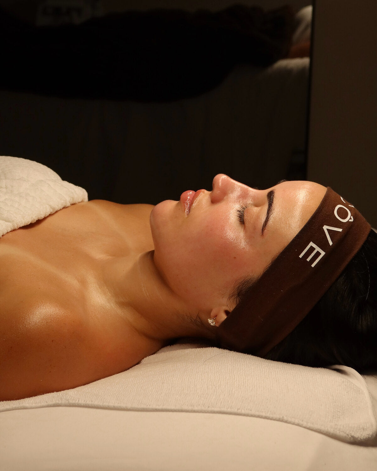 A patient relaxing during a skin treatment at Alcove's Atlanta studio
